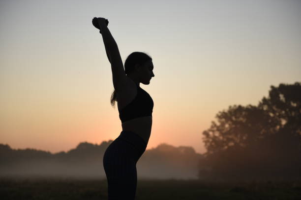 istock Young girl doing exercises outdoors. 1210388759