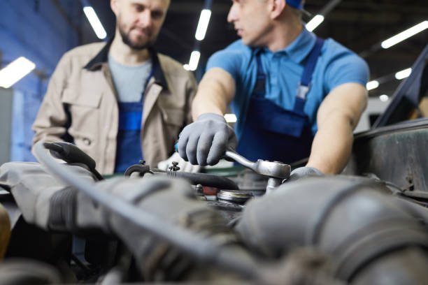 istock Repairman Fixing Car Motor Detail 1210388889
