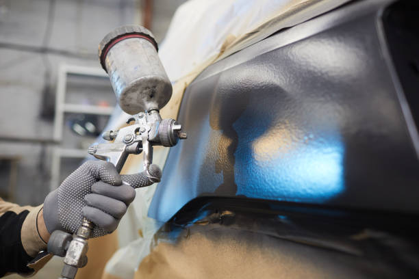 istock Unrecognizable Man Painting Car 1210389122