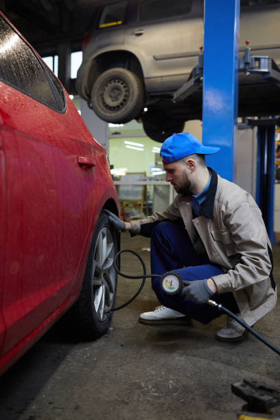 istock Repairman Checking Tyre Pressure 1210389208