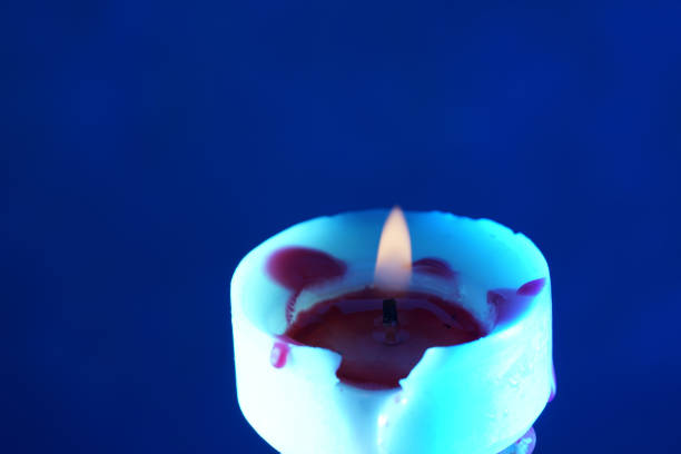 This is a candle with wax dripping photographed in the studio