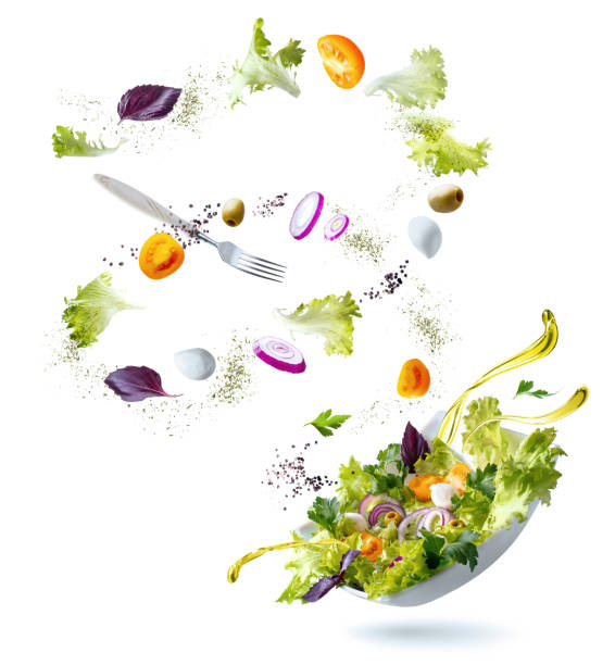istock Flying ingredients salad isolated on a white background. A white plate with salad and floating in the air ingredients: olives, lettuce, onion, tomato, мozzarella сheese, parsley, basil and olive oil. 1210391401