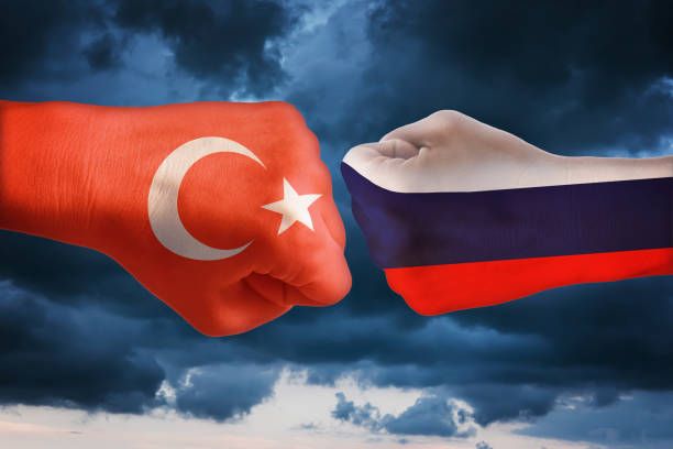Two fists with the flags of Turkey and Russia. The concept of confrontation between states stock photo