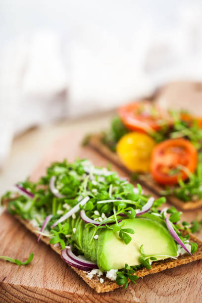 istock Avocado rye toasts with green herbs, onion and cherry tomatoes 1210401947