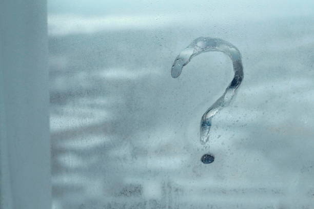 istock Question mark on a wet window pane, concept of questionnaires 1210403392
