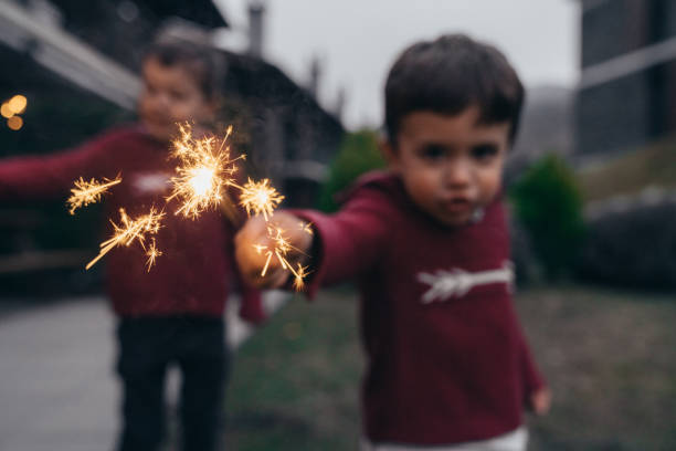 istock Boys holding sparklers for New Year's Eve 1210405252