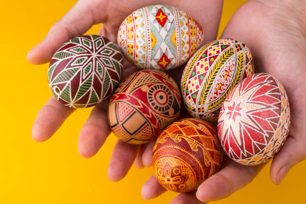 istock happy easter card. girl holds in hands beautiful Easter egg Pysanka handmade - ukrainian traditional 