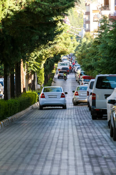 Cars parked on stone-lined road
