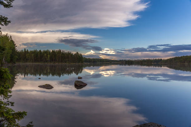 istock The sun setting over the lake with some interesting clouds in the sky. Sweden 1210408957