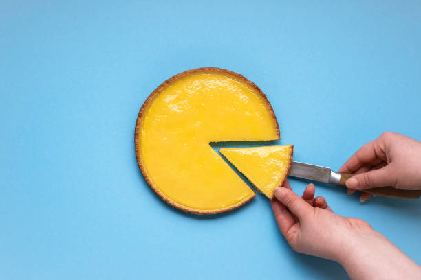 taking a piece of lemon pie. sliced lemon tart - one slice imagens e fotografias de stock