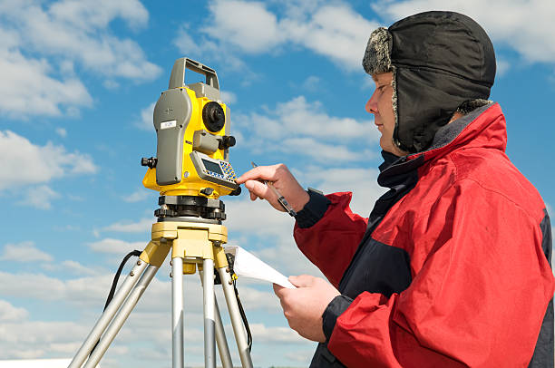 istock surveyor works with theodolite 121040981