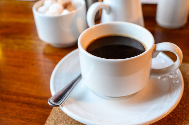 istock White cup with black coffee and  hot milk jug 1210410192