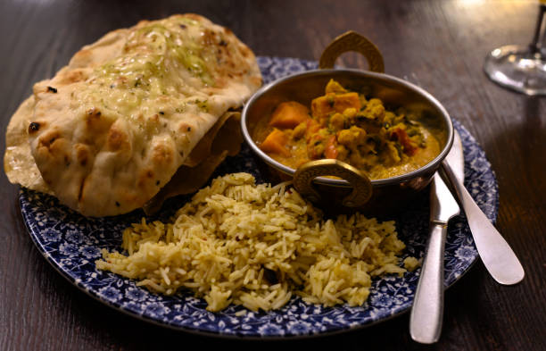 istock Mangalorean style roasted cauliflower and spinach curry with basmati rice and garlic naan bread, tasty vegetarian food 1210410209