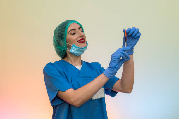 attractive nurse with syringe getting ready for injection. medical theme - surgical glove human hand holding capsule imagens e fotografias de stock