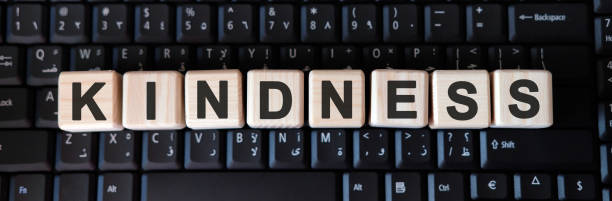 kindness word concept on cubes on the keyboard - single word love wood typescript imagens e fotografias de stock