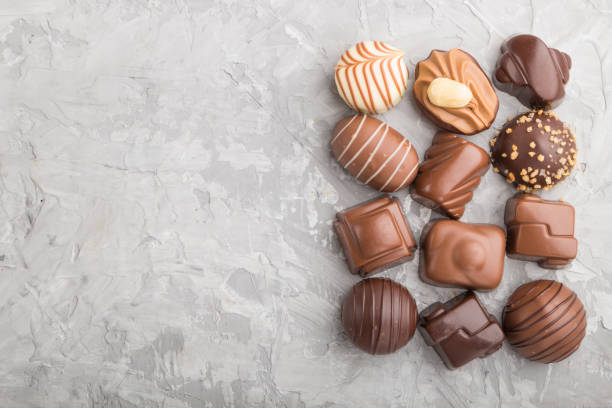 istock Different chocolate candies on a gray concrete background. top view, flat lay, copy space. 1210419474