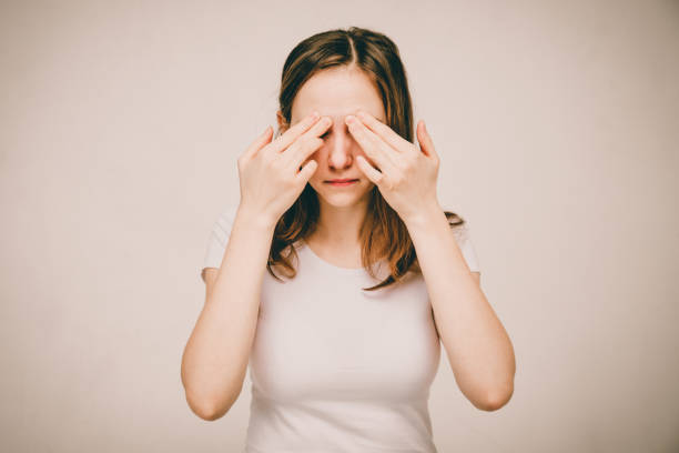 istock A girl in a white T-shirt is having memory problems. 1210420300