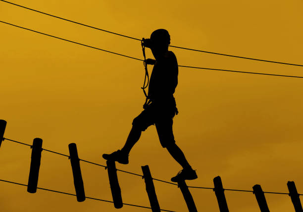 istock Man crossing a suspension bridge 1210423491