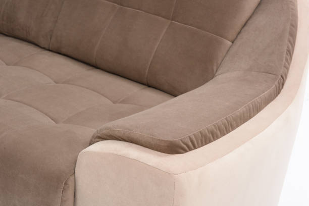 istock Closeup of cream and brown colored sofa resting arm 1210423779