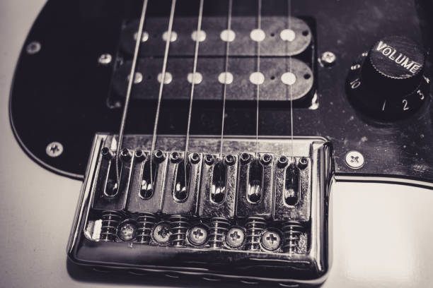 Plugging cable into electric guitar