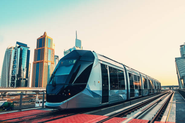 istock Metro train on rail line in Dubai downtown with skyscrapers at background 1210426201