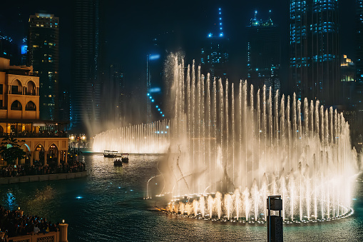 Dubai fountain with illumination at night. Popular tourist place in city downtown, UAE.