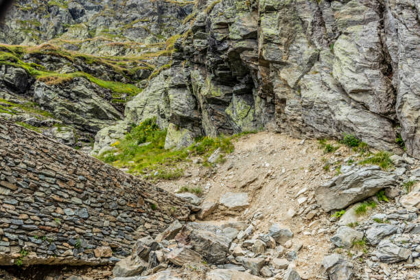 istock Rock wall in the mountains with fallen pieces of rock in front 1210426302