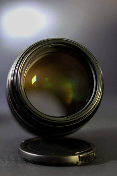 istock Professional DSLR lens on black background 1210429749