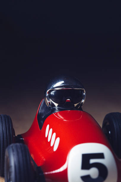 istock Vintage red toy racing car on a wooden surface 1210430497