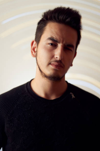 istock Young male giving blank expression in the studio with casual outfit 1210430547