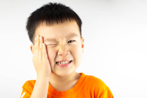 istock A little boy with his hand over his face 1210433674