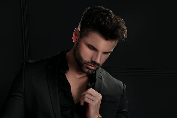 istock Man in elegant black suit posing 1210438776
