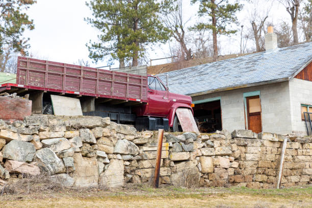 Old farm equipment and stone wall in a vineyard
