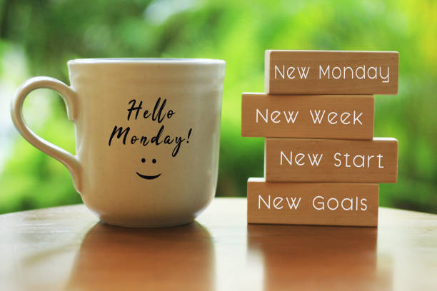 Monday concept with morning coffee cup - New Monday. New week. New start. New Goals. Hello Monday concept with inspirational motivational positive quote on wooden blocks - New Monday. New Week, New Start. New Goals. And a smiling face on a white morning cup of coffee or tea. hello single word photos stock pictures, royalty-free photos & images
