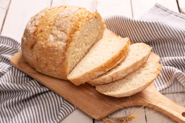istock Fresh bread on wooden table. Top view with space for your text 1210441987