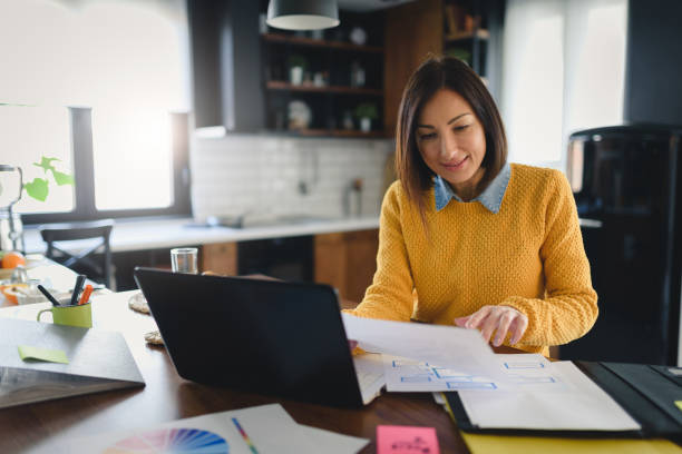 istock Young business entrepreneur woman working at home while having breakfast 1210442103