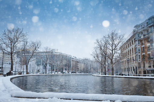 Snow covered Bassin de la Villette in Paris after heavy blizzard during day