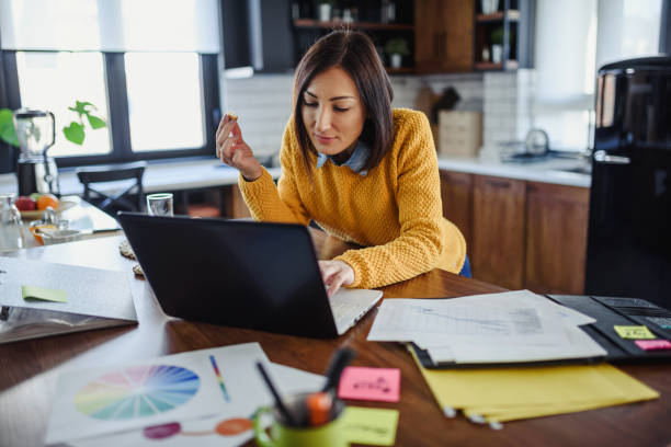 istock Young business entrepreneur woman working at home while having breakfast 1210442980