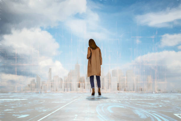 istock Young woman standing against city with augmented reality directions 1210443089