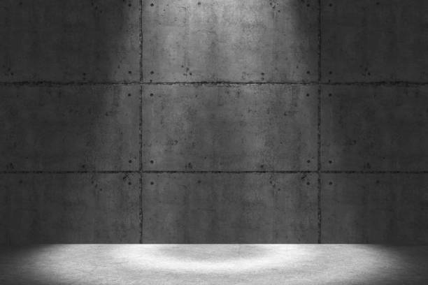 istock Spot lit urban concrete wall at night 1210443218