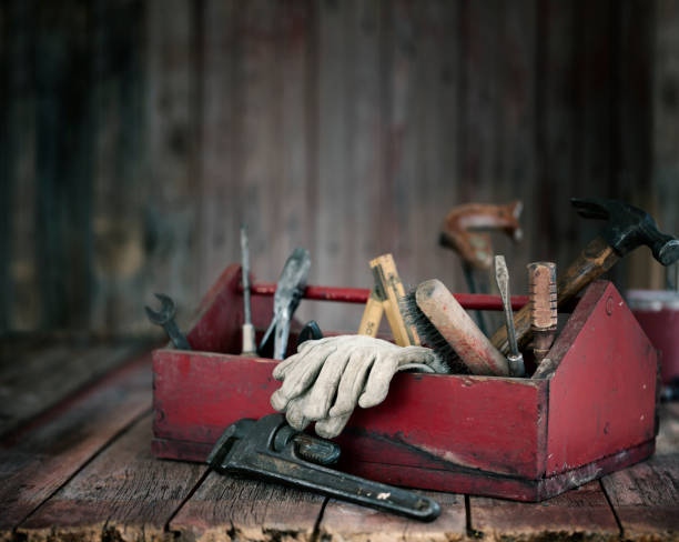 Antique Work Tools in a Toolbox Antique work tools in a red toolbox on an old wood background hammer photos stock pictures, royalty-free photos & images