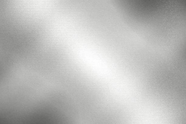 istock Light shining down on silver foil metal wall with copy space, wallpaper background 1210449357