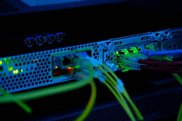 istock Close up UTP CAT6 cable with lighting bokeh and high speed network router switch in a technology data center room. 1210454172