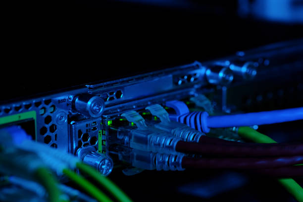 istock Close up UTP CAT6 cable with lighting bokeh and high speed network router switch in a technology data center room. 1210454185
