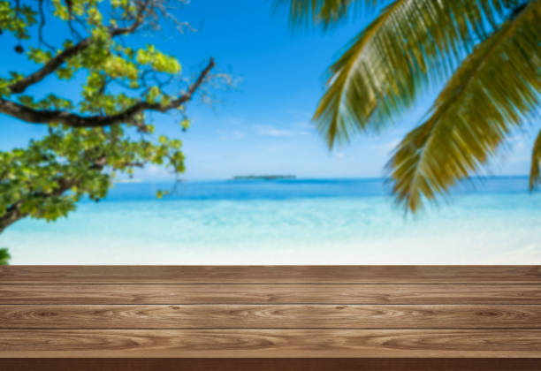 istock Brown wood table on summer tropical beach. 1210454548