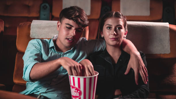istock Men and women are eating and tossing popcorn 1210456601