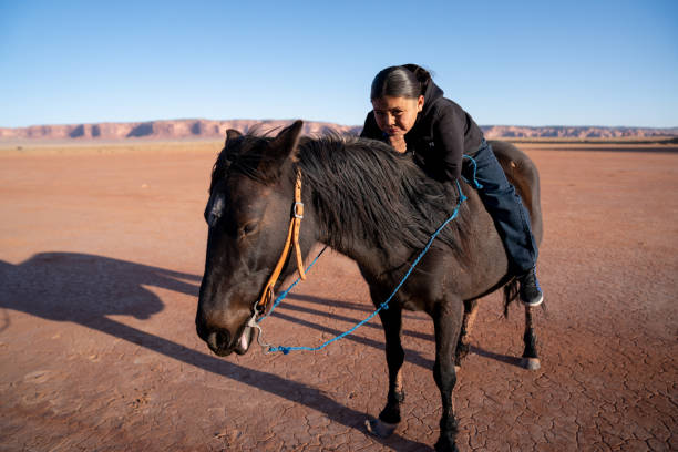 istock A Young Native American Boy, Leaning On Horse, Smiling With Confidence 1210459844
