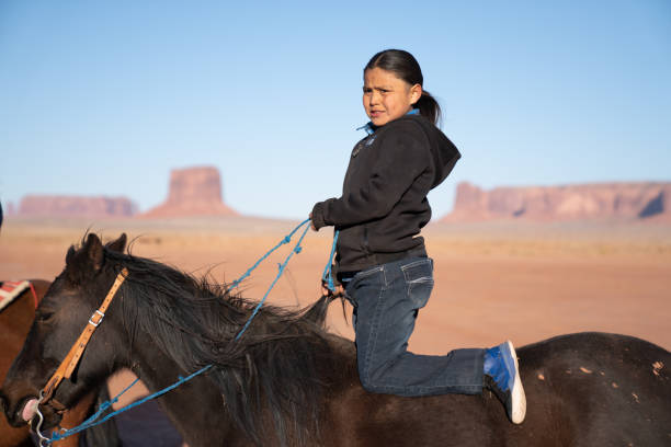 istock A Navajo Young Boy Riding Confidently On His Horse With Monument Valley Behind Him 1210459921