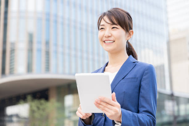 istock asian woman who see a tablet computer 1210461649
