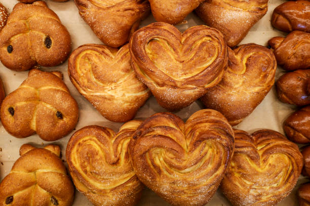 istock Modern bakery with different kinds of bread and buns. Different kinds of fresh bread as background, top view. 1210463442